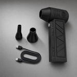Original blower with two nozzle attachments and USB charging cable on a cool silver-grey studio surface.